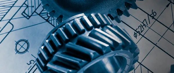 Precision gears on an engineering blueprint